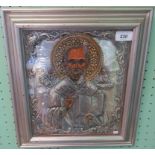 A Russian framed and glazed religious icon, depicting St Nicholas with embossed white metal Oklads,
