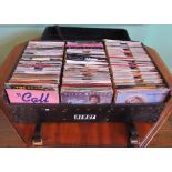 A case containing approximately four hundred 45 rpm records, ranging through the 70's and 80's,