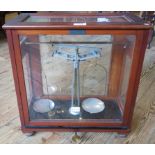 A cased set of chemist scales.