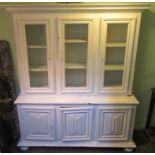 A large mahogany white painted cupboard bookcase, the upper section having three glazed doors,