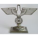 A desk paperweight depicting a Hitler Youth and Eagle Swastika Labour emblem.