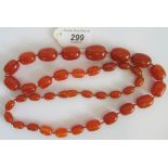 A graduated amber bead necklace.