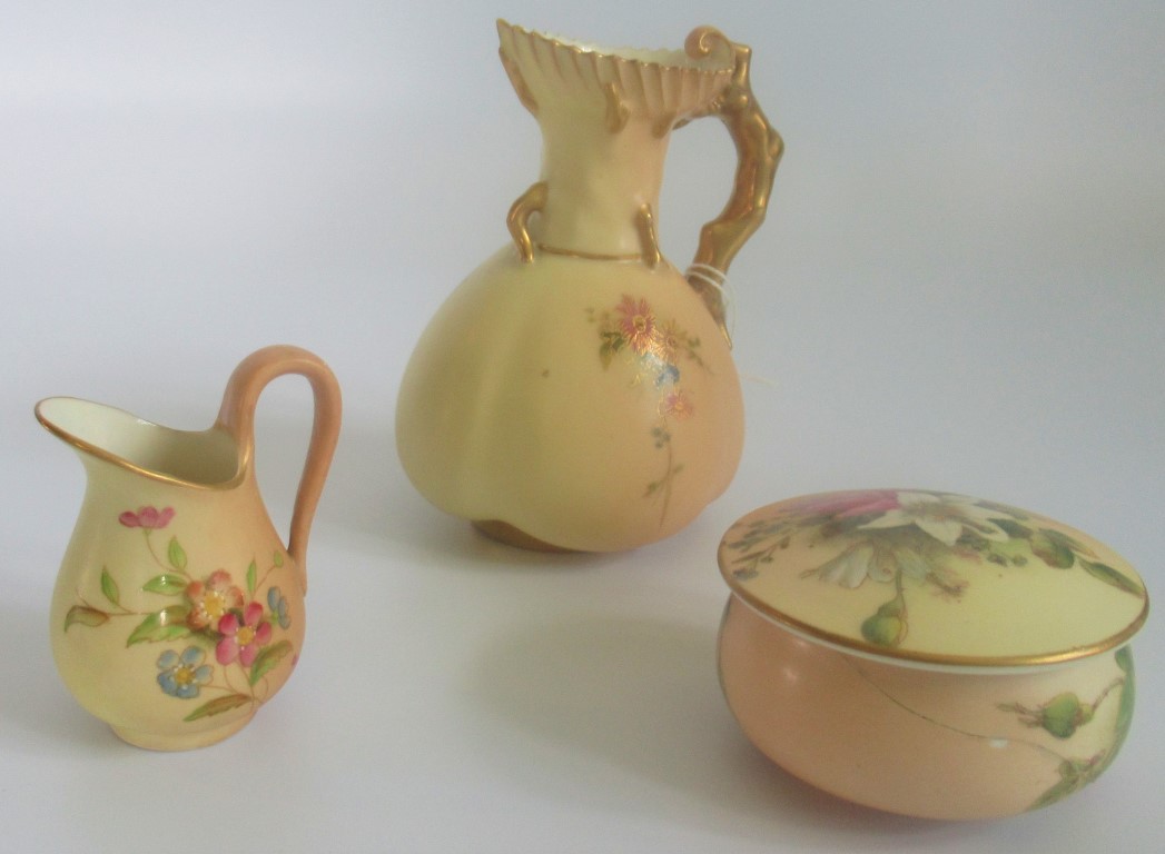 A Royal Worcester blush ivory ewer, together with a small jug and powder pot.