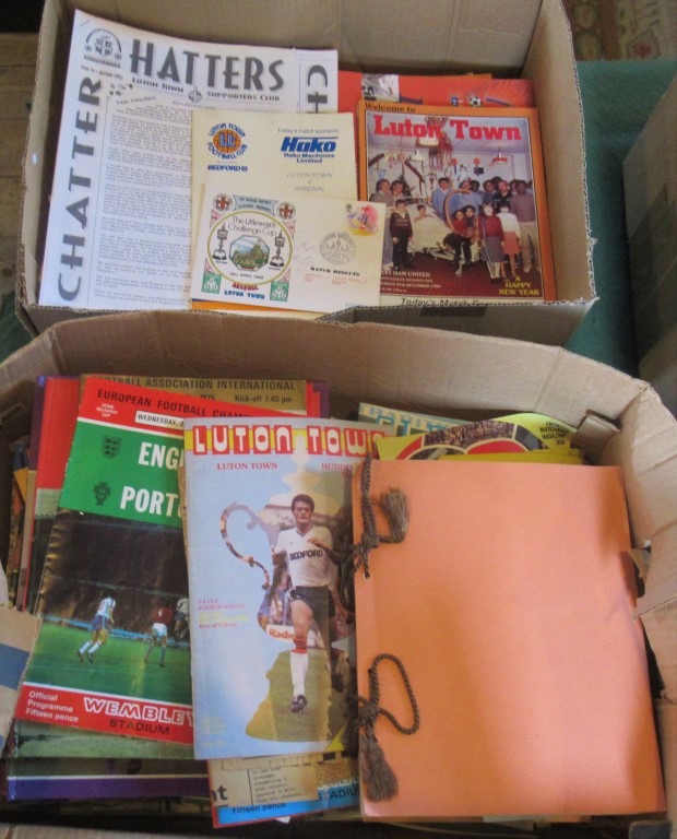 Two boxes containing a large quantity of football programmes relating to Luton Town home and away