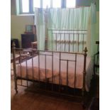 An impressive Victorian brass and iron half-tester double bed, complete with base,