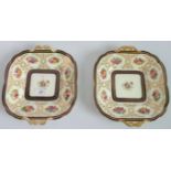 A pair of Cauldon cake plates, having floral decoration within a gilt and blue border.