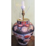 An Imari table lamp, decorated in the Oriental palette, with cream shade.