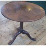 A Georgian Cuban mahogany tripod table with gun barrel pedestal and pad feet.