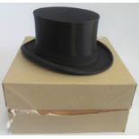 A boxed Moss Bros of Covent Garden satin top hat size 6 7/8ths.
