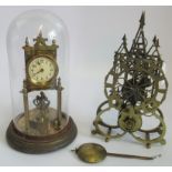 A brass skeleton clock together with another glass domed clock.