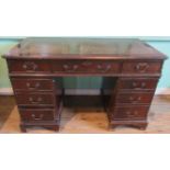 A reproduction nine draw pedestal desk.