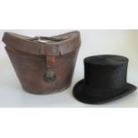 A silk top hat in original leather hat box.