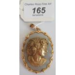 A 9ct gold pendant depicting a Victorian lady with inset diamonds.