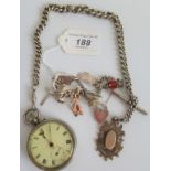 A silver charm bracelet together with a silver albert chain and a pocket watch.