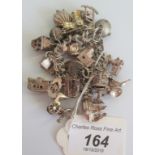 A silver charm bracelet comprising approximately 20 charms to include caravan, teapot, windmill,