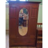 An Edwardian mahogany and inlaid single door wardrobe.