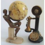 An early 20th century candlestick telephone, together with an Art Deco-style figure,