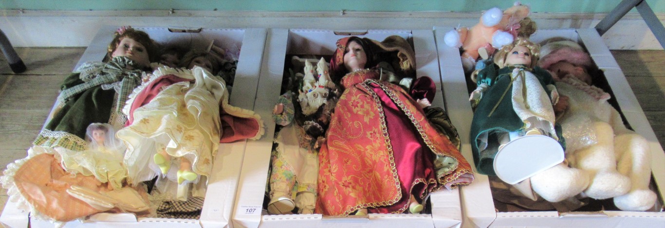 Three boxes containing a quantity of miscellaneous porcelain headed dolls.