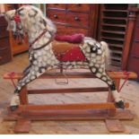 A 20th century mottled grey rocking horse on pine stand.