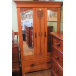 An Edwardian satinwood wardrobe.