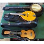 A 20th century four string banjo, together with a mandolin and a Mahalow ukulele.