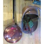 A copper coal bucket together with a copper warming pan.