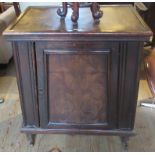 A 20th century oak Art Nouveau style free standing cupboard with decorative poker work door.