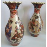 An impressive pair of 19th century Imari flared neck vases depicting geisha girls within floral