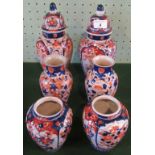 A pair of 19th century Imari lidded urns, together with two further pairs of vases.