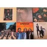 A collection of twenty-three vinyl LP's, to include: George Harrison, John Lennon, Dire Straits,