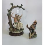 A large Capodimonte figure of a couple on a swing, together with a small Capodimonte figure.