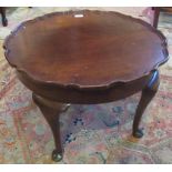 A 20th century walnut piecrust moulded circular coffee table, with cabriole legs.