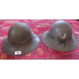 Two WWII Brodie helmets, painted in the grey of the Auxiliary Services.