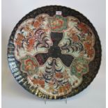 An impressive 19th century Imari charger, having three floral decorated panels on a grey ground,