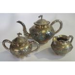 A late 19th century Chinese export silver three piece tea set with dragon motif.