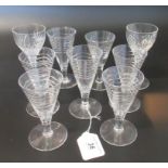 A collection of nine various liqueur glasses.