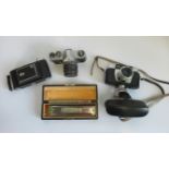 A Pentax Spotmatic camera, together with a Halina Paulette camera,