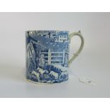 A 19th century blue and white tankard, depicting hunting scenes within a rural background.