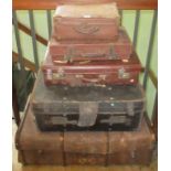 A collection of three leather graduated suitcases, together with two large trunks.