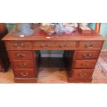 An Edwardian mahogany nine drawer pedestal desk.