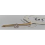 A single stone diamond bar brooch,