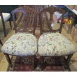 A pair of Edwardian dining chairs.