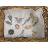 A quantity of ten miscellaneous costume brooches.