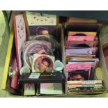 Two boxes containing a large quantity of Elvis memorabilia, to include: books, plates, mugs, mirror,