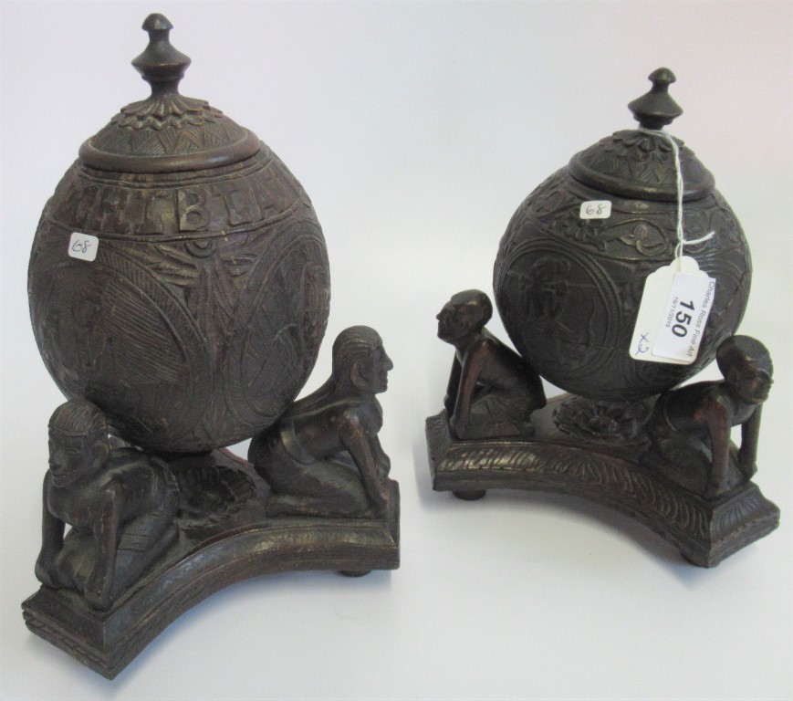 A Port Blair carved coconut cup & cover on stand, together with one other, similar.