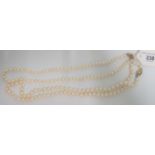 A single row cultured pearl necklace of uniform sized pearls to a 9ct gold clasp,