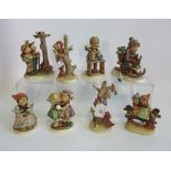 A collection of eight various Hummel figures.