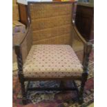 An early 20th century oak framed bergere armchair.