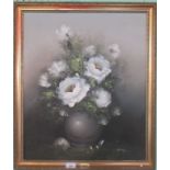 A gilt framed oil on canvas of a floral scene, indistinctly signed.
