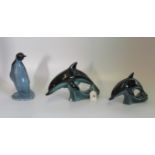 Three items of Poole pottery, to include: pair of graduated leaping dolphins,